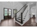 Grand foyer with dark wood floors, white staircase and wainscoting at 238 Horton Grove Rd, Fort Mill, SC 29715