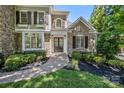 Charming front entrance with stone accents, complemented by manicured shrubs and a brick walkway at 238 Horton Grove Rd, Fort Mill, SC 29715