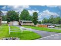 Spacious lot with a detached garage, white fence, and mature trees at 2401 Hillside Dr, Newton, NC 28658