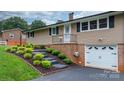 Inviting single-story home with a well-manicured lawn and integrated garage at 2401 Hillside Dr, Newton, NC 28658