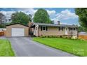 Attractive single-story home with a detached garage and well-maintained landscaping at 2401 Hillside Dr, Newton, NC 28658