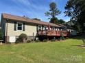 Backyard with deck, manicured bushes, large windows and well-maintained lawn at 2401 Hoffman St, Gastonia, NC 28054