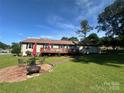 Spacious backyard with patio, deck, seating, fire pit, and well-maintained lawn at 2401 Hoffman St, Gastonia, NC 28054