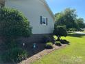 Landscaped yard with manicured shrubs and brick foundation at 2401 Hoffman St, Gastonia, NC 28054