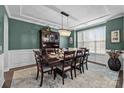Elegant dining room with a large window, ornate chandelier, and stylish furnishings at 2414 Madeira Cir, Waxhaw, NC 28173