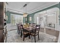 Dining room with an arched entryway, chandelier, large table, and view into an adjacent room at 2414 Madeira Cir, Waxhaw, NC 28173