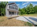 Two-story home with gray siding, black shutters, and a charming covered porch at 304 Adams St, Salisbury, NC 28144
