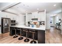 Modern kitchen with stainless steel appliances, center island, and breakfast bar seating at 4005 Easton Ridge Ln, Charlotte, NC 28226