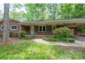 Close up of the home's brick facade and charming front porch with decorative columns at 403 Cherrywood Ln, Albemarle, NC 28001
