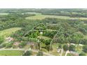 Expansive aerial view of wooded property with home, highlighting the lot's size and privacy at 4335 E Nc 10 Hwy, Claremont, NC 28610