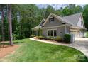 Well-maintained home with a two-car garage, neat landscaping, and a sidewalk leading to the front door at 4660 Gold Finch Dr, Denver, NC 28037