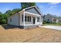 Attractive single-story home featuring a covered front porch, complemented by fresh landscaping at 528 S Caldwell St, Salisbury, NC 28144