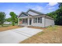 Well-maintained single-story home with a concrete driveway and freshly landscaped front yard at 528 S Caldwell St, Salisbury, NC 28144