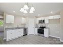 Bright kitchen with white cabinets, stainless steel appliances, and granite countertops at 528 S Caldwell St, Salisbury, NC 28144