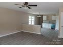 Open-concept living room featuring modern flooring, neutral paint, and access to the kitchen with stainless appliances at 528 S Caldwell St, Salisbury, NC 28144
