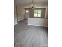 Open-concept living room featuring modern flooring and neutral paint at 528 S Caldwell St, Salisbury, NC 28144