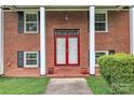 Close-up of the front door with red trim and white columns at 5633 Mallard S Dr, Charlotte, NC 28227