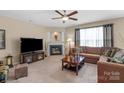 Inviting living room with a cozy fireplace, plush seating, and ample natural light at 6104 Follow The Trl, Indian Trail, NC 28079