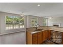 Open concept kitchen with granite countertops and stainless steel appliances; a seamless space at 6614 Truman St, Indian Trail, NC 28079