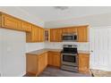Bright kitchen featuring stainless steel appliances, granite countertops, and classic wood cabinets at 6614 Truman St, Indian Trail, NC 28079