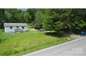 Charming single story cottage-style home with a small porch and a lush green lawn at 6649 Mountain Grove Rd, Hickory, NC 28602