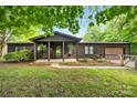 Charming log cabin with a cozy front porch and well-maintained landscaping at 6822 Zelda Dr, Catawba, NC 28609
