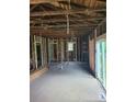 Interior view of a home under construction, featuring exposed wooden beams and framing and a sliding glass door at 720 Mutual Rd, Gastonia, NC 28052