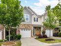 Inviting townhome boasts a well-maintained yard, attached garage, and appealing brick accents at 7325 Overmountain Dr, Rock Hill, SC 29732