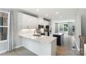 Bright, modern kitchen featuring white cabinets, stainless steel appliances, and a center island at 743 Anderson St, Charlotte, NC 28205