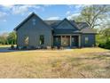 Charming single Gathering home featuring a craftsman style elevation, well manicured lawn and inviting front porch at 919 Village Lake Dr, Monroe, NC 28110