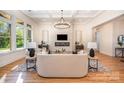 Bright living room with fireplace, elegant lighting fixture, and open concept layout with hardwood floors at 919 Village Lake Dr, Monroe, NC 28110