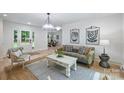 Inviting living room featuring natural light, neutral tones, and an open layout to dining at 9520 Squirrel Hollow Ln, Charlotte, NC 28270