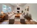 Bright living room with a fireplace, hardwood floors, and neutral furniture staging at 10319 Willingham Rd, Huntersville, NC 28078