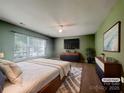 Bedroom with modern furniture, ceiling fan, and a large window at 10319 Willingham Rd, Huntersville, NC 28078