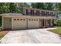 Attractive two-story home featuring a two-car garage, red shutters, and a well-maintained lawn at 10327 Shelter Rock Ct, Charlotte, NC 28214