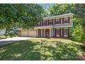 Charming two-story home with red shutters, vinyl siding, a covered porch and a two-car garage at 10327 Shelter Rock Ct, Charlotte, NC 28214