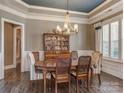Dining room with chandelier, stylish chairs, and white trim at 114 Reserve Ln, Fort Mill, SC 29707