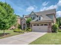 Lovely home boasts a two car garage and a concrete driveway with beautiful landscaping at 114 Reserve Ln, Fort Mill, SC 29707