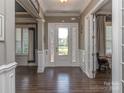 Inviting foyer with hardwood floors, neutral walls and a storm door to let the light in at 114 Reserve Ln, Fort Mill, SC 29707
