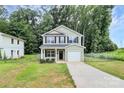 Charming two-story home with light green siding, black shutters, and an attached one car garage at 1218 Rosada Dr, Charlotte, NC 28213