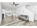 Open concept living room featuring modern gray flooring, neutral walls and ample natural light at 1218 Rosada Dr, Charlotte, NC 28213