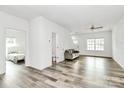 Spacious living area showcasing modern flooring, bright white walls, and open doorway to Primary at 1218 Rosada Dr, Charlotte, NC 28213