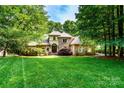 Charming brick home boasts mature landscaping and a meticulously manicured lawn at 122 Sleepy Cove Trl, Mooresville, NC 28117