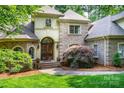 Elegant home featuring a detailed front door and brick facade at 122 Sleepy Cove Trl, Mooresville, NC 28117