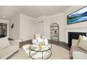 Well-lit living room featuring modern decor, fireplace, and neutral colors at 125 Noah Ln, Troutman, NC 28166