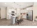 Modern kitchen features stainless steel appliances, a center island, and pendant lighting at 13221 Gadwal Pintail Dr, Charlotte, NC 28262