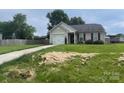 A single-story home with attached garage and well-maintained lawn with some hay spread out on the front yard at 1381 Steven Dr, Salisbury, NC 28147