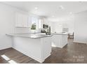 Contemporary kitchen featuring white cabinets, granite countertops, stainless steel appliances, and hardwood floors at 1433 Harleston St, Indian Trail, NC 28079