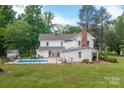 Beautiful backyard featuring a sparkling swimming pool and well-manicured lawn, perfect for outdoor enjoyment and relaxation at 1567 Jennings Rd, Statesville, NC 28625