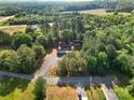 A home is surrounded by a lush forest in this aerial view at 1811 Continental Dr, Albemarle, NC 28001